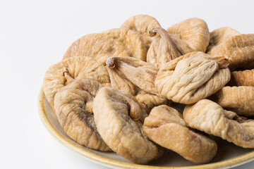 Dried fig on plate on white background