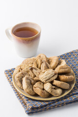 Dried fig on plate on white background