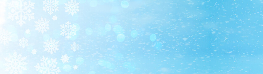 snowflakes and ice crystals isolated on blue sky illuminated by the sun - winter background panorama banner long