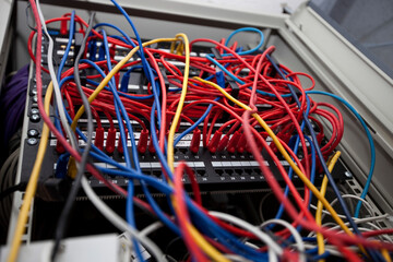 Low angle of tangled wires in server room at television station