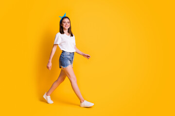 Full length profile side photo of charming brown haired girl happy walk wear blue pin-up isolated on bright color background