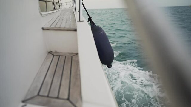 Water splashing on the side of a yacht (slow motion)