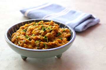Baigan Bharta, also called Vangyache Bharit in Marathi. It is a roasted eggplant curry. Brinjal chutney. served in a wooden bowl with rice roti or tandalachi bhakri. copy space.