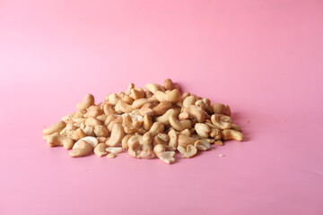 cashew nut on pink background with copy space 