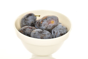 Several ripe organic Damson plums, close-up, isolated on white.