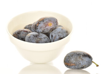 Several ripe organic Damson plums, close-up, isolated on white.