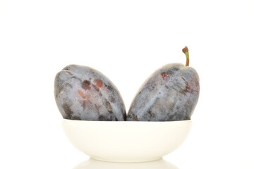 Several ripe organic Damson plums, close-up, isolated on white.