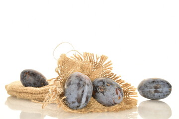 Several ripe organic Damson plums, close-up, isolated on white.