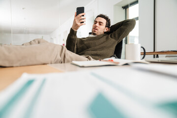 Confident young man manager in office