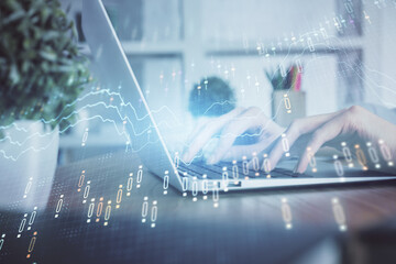 Double exposure of woman hands typing on computer and forex chart hologram drawing. Stock market invest concept.