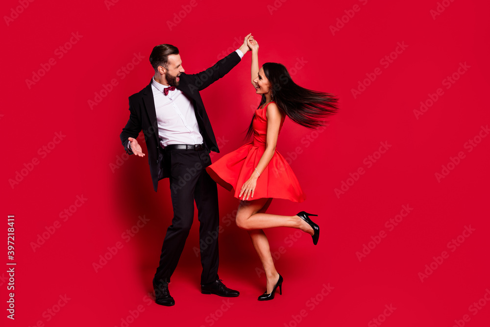 Poster full length photo of two positive persons dancing have great time isolated on red color background
