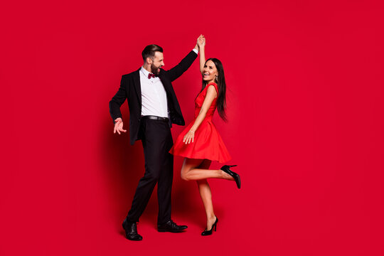 Full body portrait of carefree handsome guy attractive lady have fun enjoy dance isolated on red color background