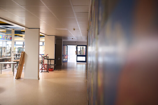 Empty School Hallway With Art On Wall