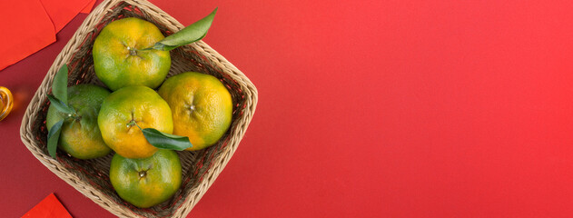 Top view of fresh tangerine mandarin orange on red background for Chinese lunar new year.