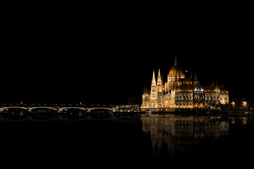 Fototapeta na wymiar The Hungarian Parliament building illuminated at night. Night landscape of Budapest and Danube River, Hungary