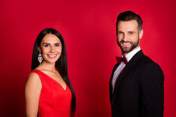 Photo of nice optimistic couple wear suit dress isolated on red color background