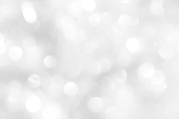 Naklejka na ściany i meble White sparkles with blurry circles texture, soft bokeh for a beautiful new year screensaver. Template for decoration of a holiday postcard, web design.