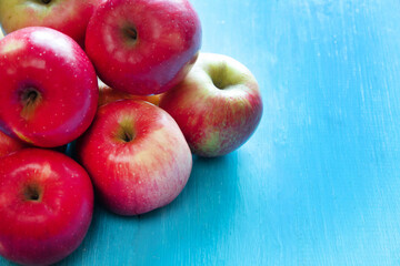 Natural fresh organic apples on a blue background