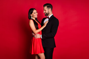 Profile photo of optimistic couple hug look wear suit dress isolated on red color background