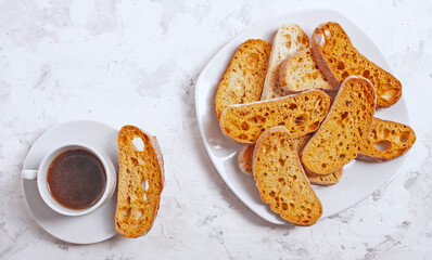 White ceramic cup with coffee and crackers on a white background. With copy space.