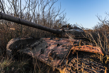 rusty old tank on a testground in the nature