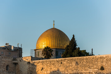 Fototapeta na wymiar Close-up of Golden Dome of the Rock, Qubbat al-Sakhrah, under sunset on Temple Mount of Old City of Jerusalem, Israel. One of the oldest extant works of Islamic architecture