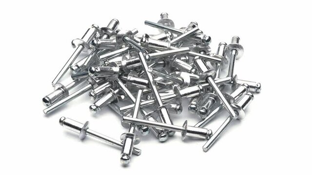 Close-up view of a heap of blind rivets, isolated on white, seamless loop rotation