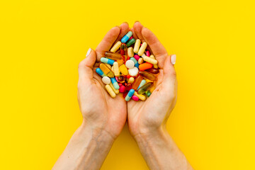 Heap of pills in hands from above