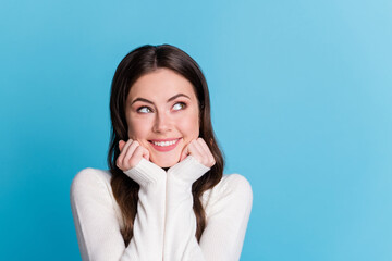 Photo of charming adorable wavy lady wear white sweater arms chin looking empty space isolated blue color background