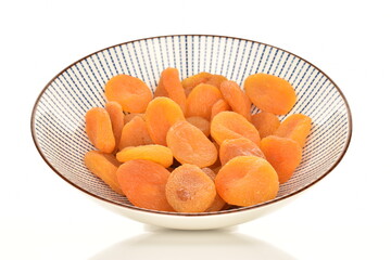 Bright orange natural dried apricots, close-up, isolated on white.