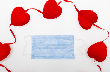 Surgical face mask and red heart shape. covid-19 concept