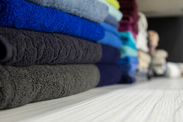 
different color towels folded in the bathroom as background