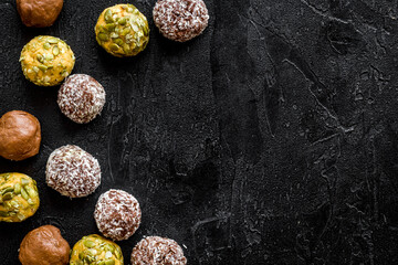 Fototapeta na wymiar Flat lay of raw protein energy balls with nuts and cacao, top view