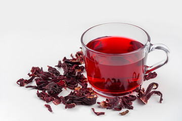 Hibiscus tea glass cup and dried flowers on white background. Vitamin, recipe, beverage concept....