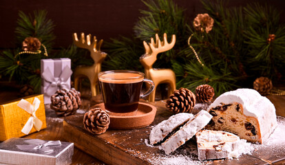 Small cup of black coffee and pastries. Traditional German sweet bread with dried fruits and marzipan for Christmas. Stollen and aromatic espresso coffee with gift boxes . Copy space