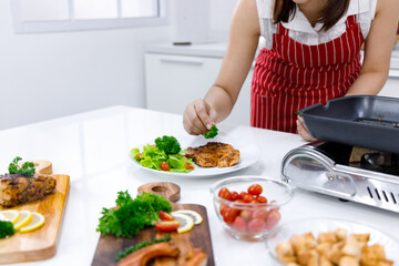 chef putting parsley on pork steak.
