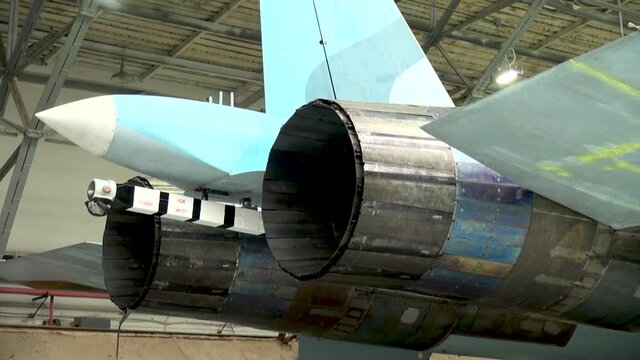 Checking the performance of a special hook with which the plane clings to brake cables during landing. Close-up. Maintenance of Su-33 fighter (NATO codification: Flanker-D). 
