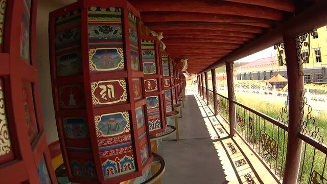 Close up view of rolling prayer wheels in buddhist monastery. Tibetan Plateau in Qinghai Province, Amdo region, China.