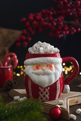 Christmas decoration with snowman and candle. Mug of santa claus. Christmas mug. Cocoa with marshmallows for the new year.