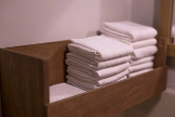 Fototapeta na wymiar stack of white towels in vintage bathroom.