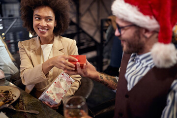 multiethnic couple exchanging presents. new year celebration concept