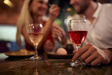 A young couple in love enjoying food and drink at Valentine's day celebration at a restaurant. Together, Valentine's day, celebration