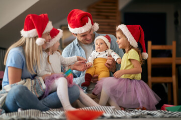 Obraz premium Happy family celebrating New Year at home. New Year, family concept, together, love