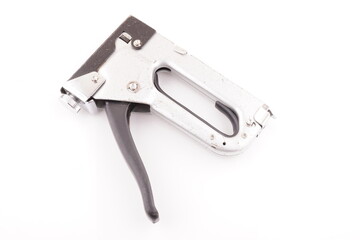 metal construction stapler on white background