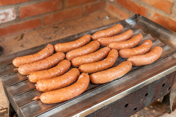 Grilled sausages on grill