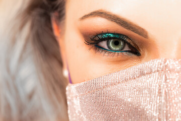Womans face in glitter protective mask, amazing make-up. Female with shining shadows. Nightlife,...