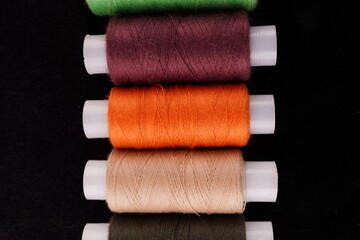 colored threads on a black background