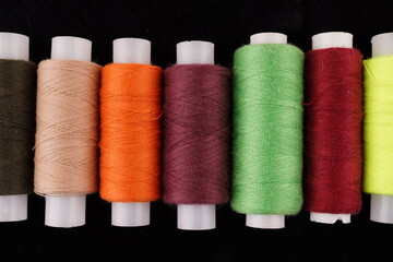 colored threads on a black background