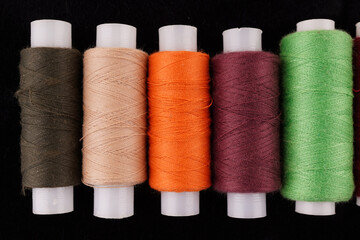 colored threads on a black background