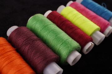 colored threads on a black background